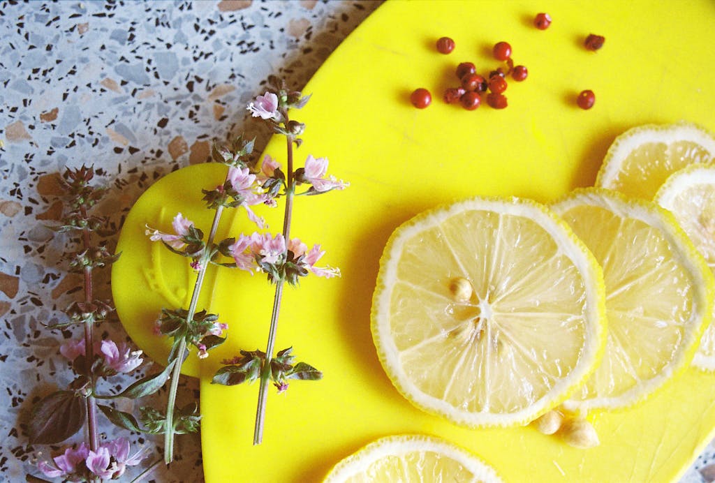 Basil, red pepper and lemon slices on a cutting board